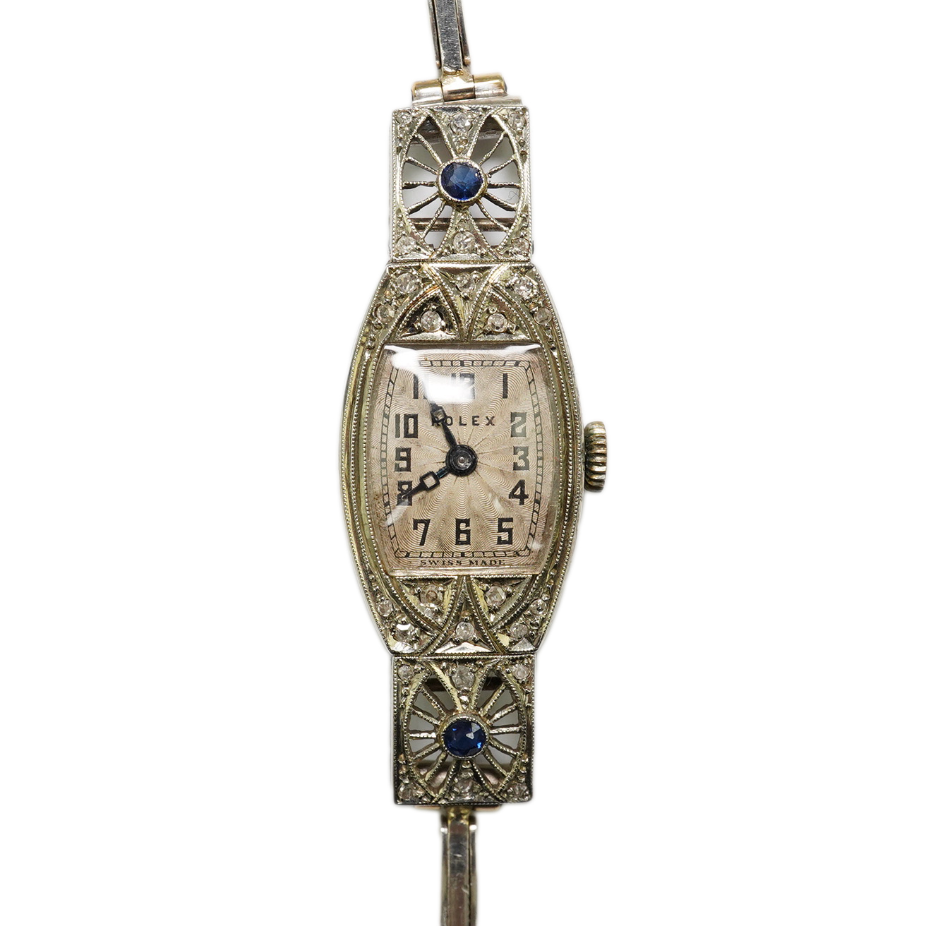 A lady's 1930's Art Deco pierced 18ct gold, sapphire and diamond set Rolex manual wind cocktail watch, on an 18ct gold and platinum expanding bracelet